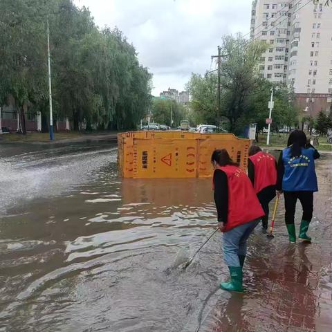 平安社区网格员冒雨疏通排水口，做好辖区防汛工作