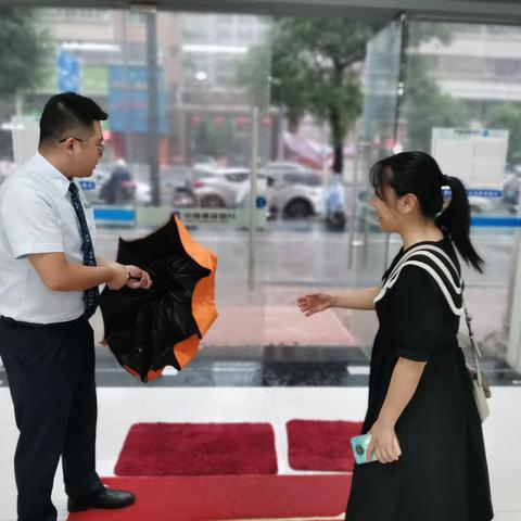 雨中送伞显真情 建行服务人人夸