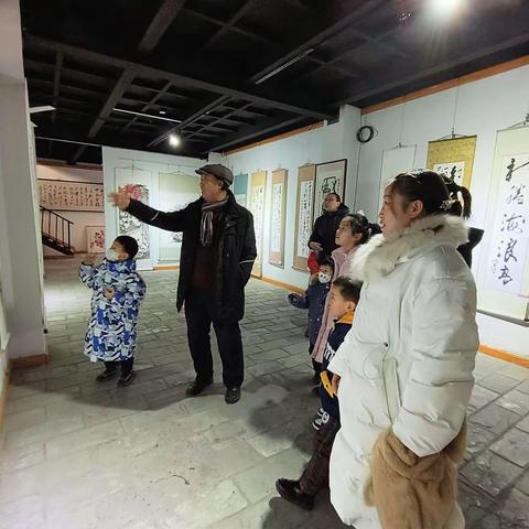 阳光社区图书馆组织家长和小朋友参观书画剪纸摄影精品展览